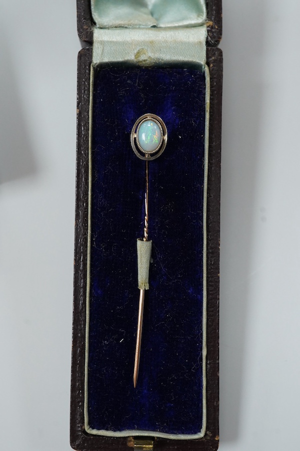 A cased late Victorian 9ct and single stone amethyst set bar brooch, 45mm, a cased yellow metal and single stone white opal set stick pin and a modern 18ct white gold, ruby and diamond cluster ring, size L/M.